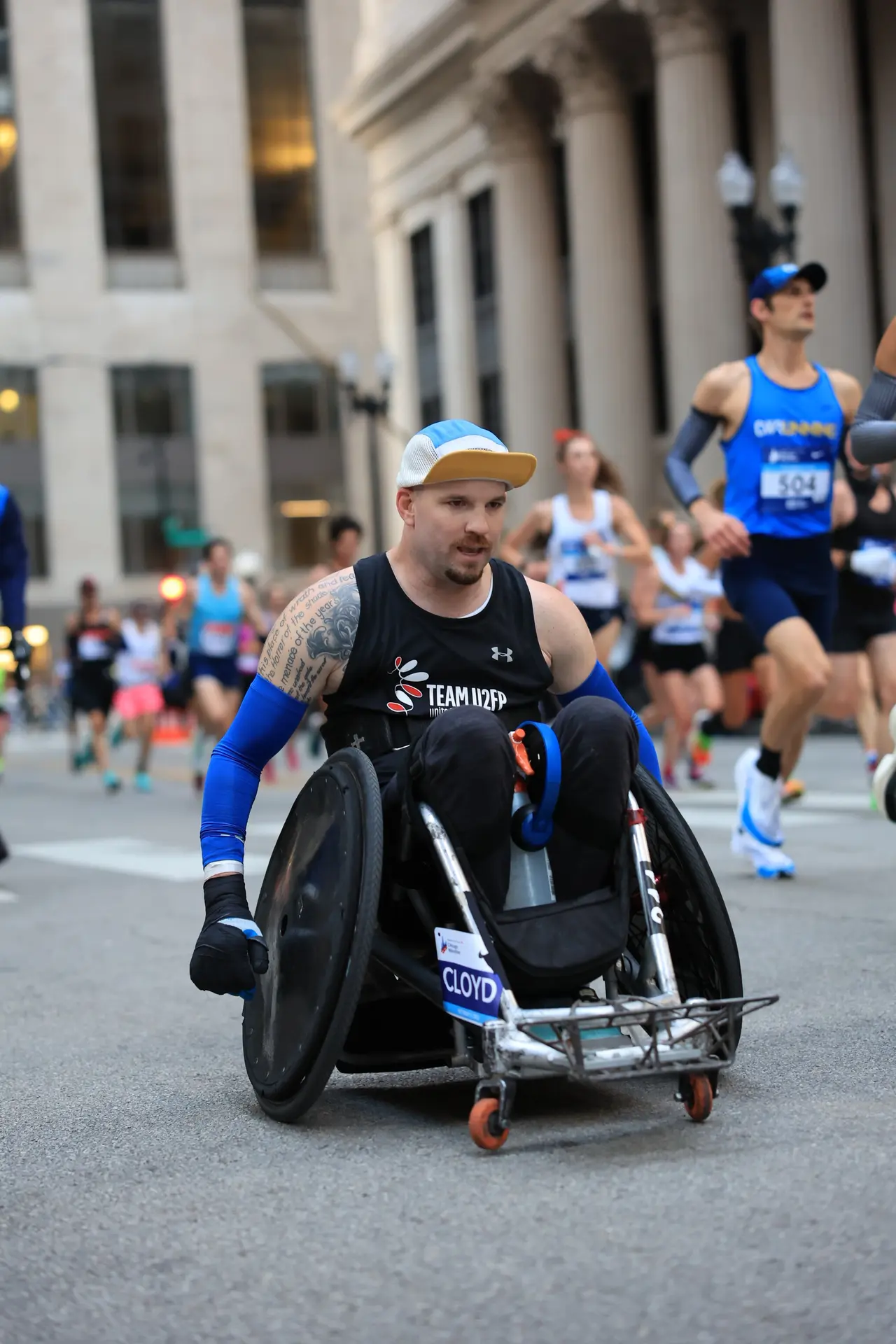 Thomas Cloyd pushing his quad rugby chair through the streets of Chicago
